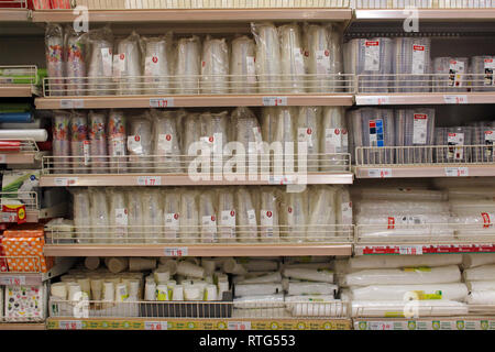 Stack of food plastic disposable glasses and cutlery displayed on a supermarket Stock Photo