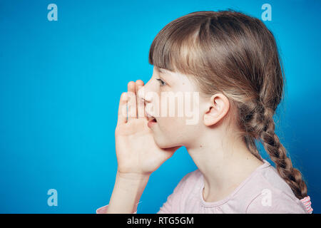 smiley naughty girl sharing a secret. gossip communication and information concept Stock Photo