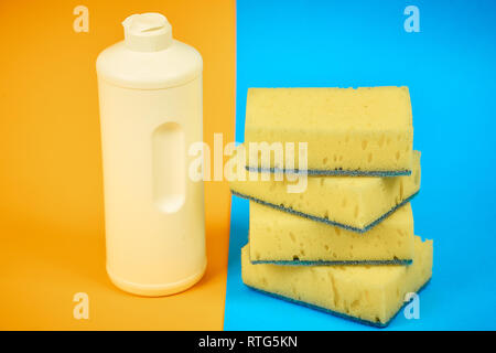means for washing dishes and sponges on a colored background. household chores Stock Photo