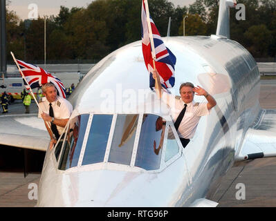 File photo dated 24/10/2003 of Captain Mike Bannister (R) and Senior First Officer Jonathan Napier (L) waving from the cockpit of a British Airways Concorde after landing at London's Heathrow Airport, on the day that the world's first supersonic airliner retired from commercial service. Stock Photo