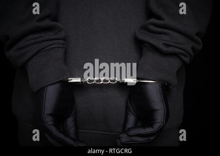 arrested man in handcuffs with hands on back Stock Photo