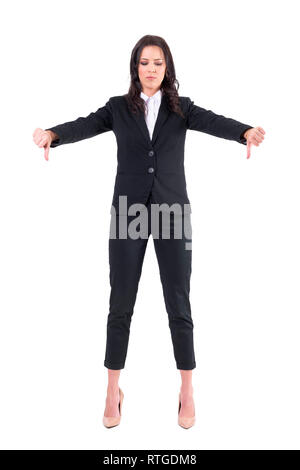 Sad upset business woman with thumbs down gesture looking down. Full body isolated on white background. Stock Photo