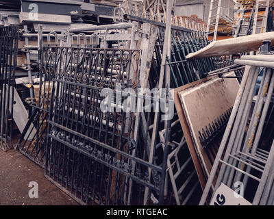 A collection of stacked wrought iron gates at a salvage yard in the UK. Stock Photo