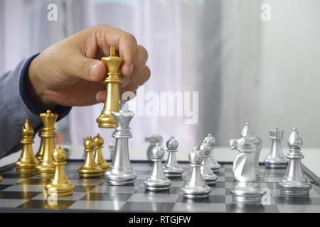 Businessman playing chess game; business strategy, leadership and management concept. Stock Photo