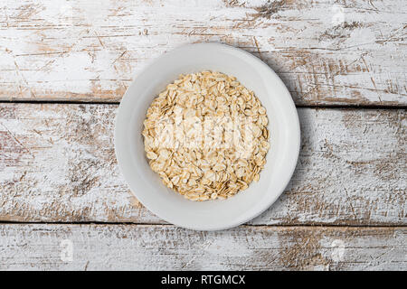 white plate with oat braids on white background Stock Photo