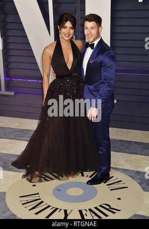 BEVERLY HILLS, CA - FEBRUARY 24: Priyanka Chopra (L) and Nick Jonas attend the 2019 Vanity Fair Oscar Party hosted by Radhika Jones at Wallis Annenber Stock Photo
