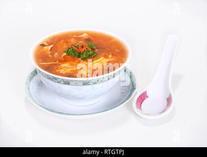 Traditional Chinese soup with typical Chinese / Asian dishes and spoon Stock Photo