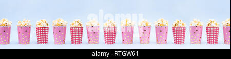 Banner of several cups of popcorn on a blue background Copy space Stock Photo