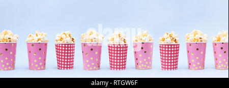 Banner of several cups of popcorn on a blue background Copy space Stock Photo