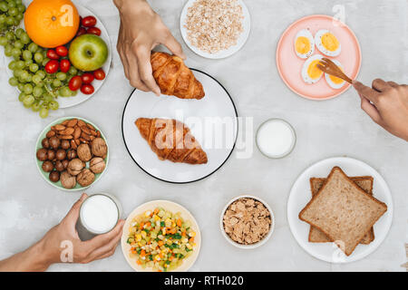 Healthy breakfast ingredients on black concrete background. Oat flakes, almond milk, nuts, fruits and berries. Healthy lifestyle, dieting, healthy eat Stock Photo