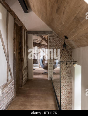 Medieval brickwork  and oak beams  with glass balustrade Stock Photo