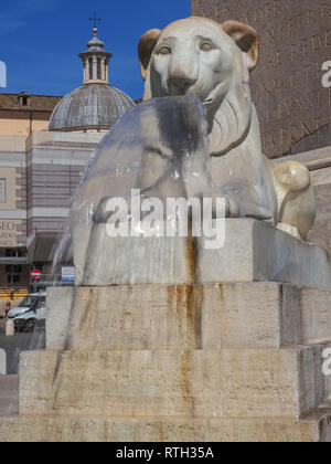 In Piazza del Popolo is group of four mini fountains, each comprising a lion on stepped plinth, surround obelisk Flaminio. Water flows from lion mouth Stock Photo