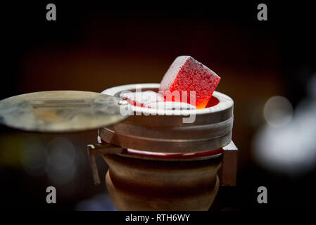 Coals on bowl of hookah for tobacco smoking close up on dark background. Stock Photo