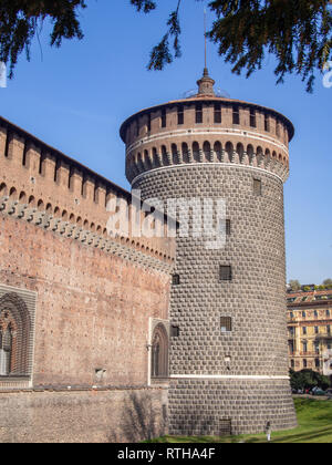 Tower of the Sforza Castle (Castello Sforzesco) through the jets of the fountain. Milan, Italy Stock Photo