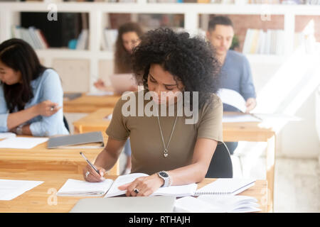 Focused african female college high school student studying in classroom  Stock Photo