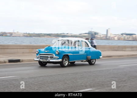 Classic 1950's American car road trip driving along the Malecon in Havana Cuba Stock Photo