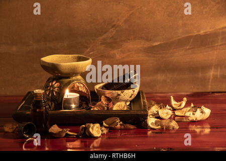 Aroma lamp with essential oil and potpourri on wooden table background. Stock Photo