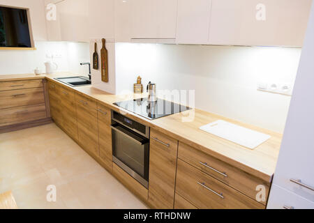 Aesthetic modern narrow kitchen with wooden furnitures Stock Photo