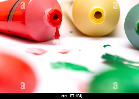 Paint drops out of acrylic tube. Paint squeezed out of the tube Stock Photo