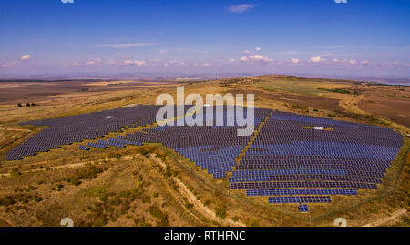 Solar panel produces green, environmentaly friendly energy from the setting sun. Aerial view from drone. Landscape picture of a solar plant Stock Photo