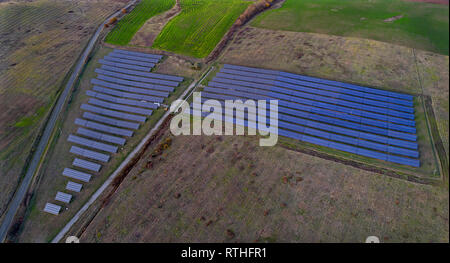 Solar panel produces green, environmentaly friendly energy from the setting sun. Aerial view from drone. Landscape picture of a solar plant Stock Photo