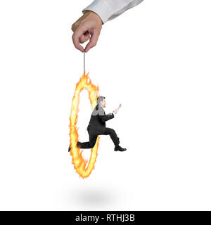 Businessman jumping through fire circle hand holding isolated on white background Stock Photo