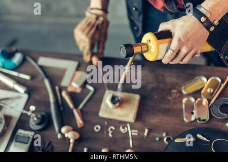 jeweler maker using a soldering torch, close up cropped photo Stock Photo
