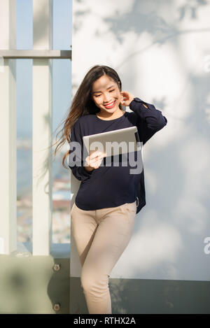 Young beautiful Asian woman working with laptop/internet/online shopping at outdoor park, smile/fresh and happy relaxing feeling in the morning, freel Stock Photo