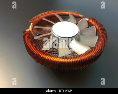 CPU cooler with copper plates on a gray background Stock Photo