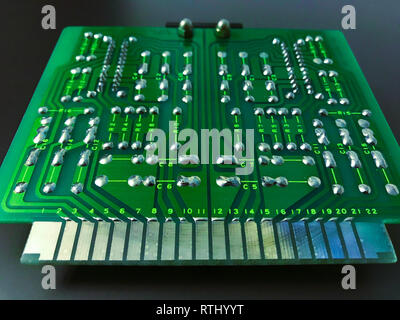 Shot of the back side of a green computer circuit board on black background Stock Photo