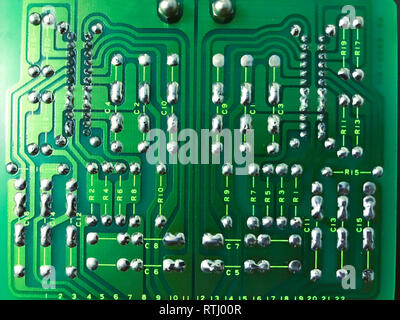 Shot of the back side of a green computer circuit board on black background Stock Photo