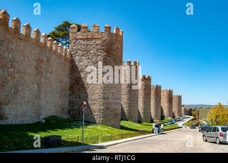 Avila, Spain; May 2013: Mighty medieval wall and towers surrounding the old town of Avila, Spain Stock Photo