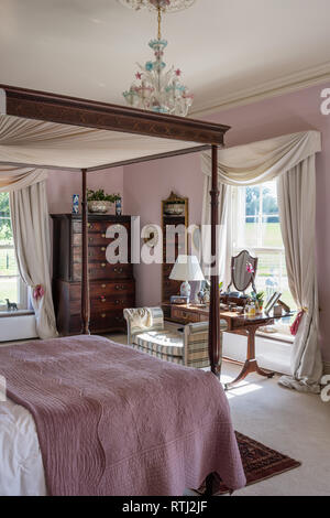 Soft furnishings with floral print by Zoffany with four-poster bed bought at auction Stock Photo