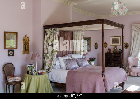 Soft furnishings with floral print by Zoffany with four-poster bed bought at auction Stock Photo