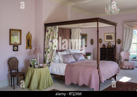 Soft furnishings with floral print by Zoffany with four-poster bed bought at auction Stock Photo