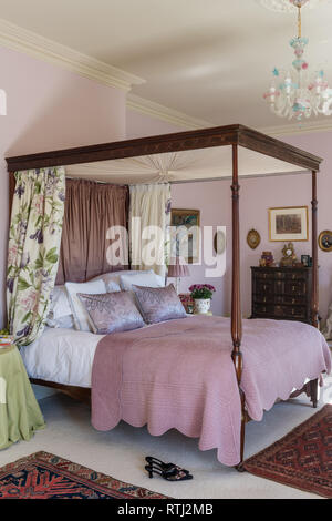 Soft furnishings with floral print by Zoffany with four-poster bed bought at auction Stock Photo