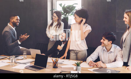 Business team having break and talking at meeting Stock Photo