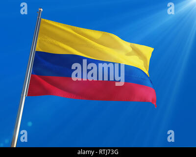 Colombia National Flag Waving on pole against deep blue sky background. High Definition Stock Photo