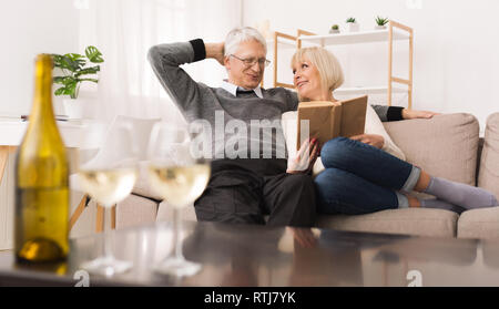 Mature couple looking album, spending time together Stock Photo
