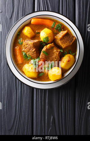 Namibia Potjiekos traditional lamb dish with vegetables close-up in a bowl on the table. Vertical top view from above Stock Photo