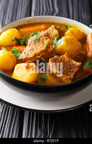 Potjiekos is one of the most authentic South African dishes from lamb and vegetables close-up in a bowl on the table. vertical Stock Photo