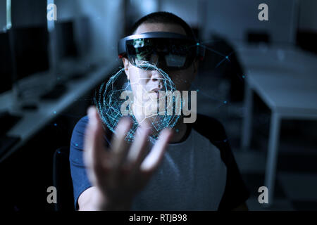 Men steps into virtual reality world with microsoft hololens 1 Stock Photo