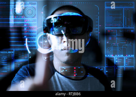 Men steps into virtual reality world with microsoft hololens 1 Stock Photo