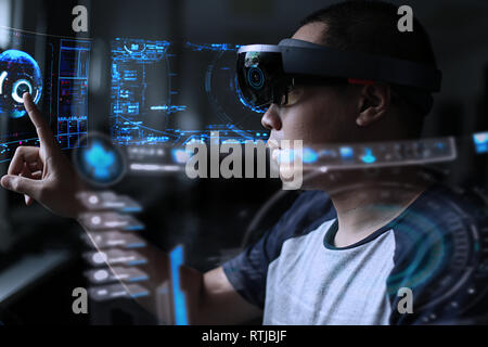 Men steps into virtual reality world with microsoft hololens 1 Stock Photo