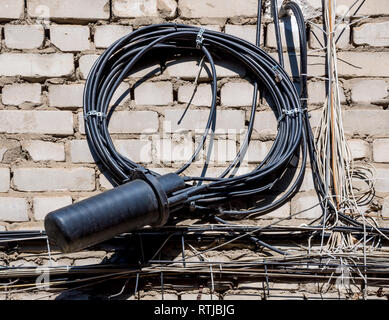 Twisted telephone cable and coupler on the wall of the house Stock Photo