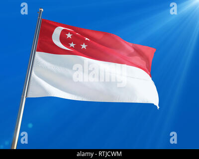 Singapore National Flag Waving on pole against deep blue sky background. High Definition Stock Photo