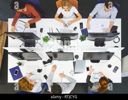 Diverse young team working at coworking place, top view Stock Photo