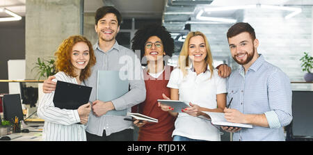 Diverse business people standing together and smiling. Stock Photo