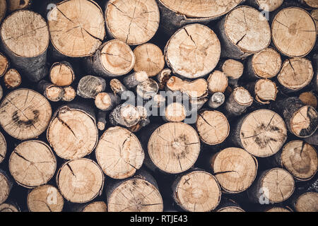 Pile of cut wooden logs. Stacked firewood background. Stock Photo