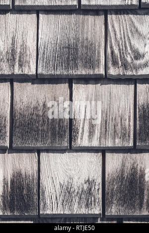 Gray wooden tiles texture. Detail of a rustic house wall. Stock Photo